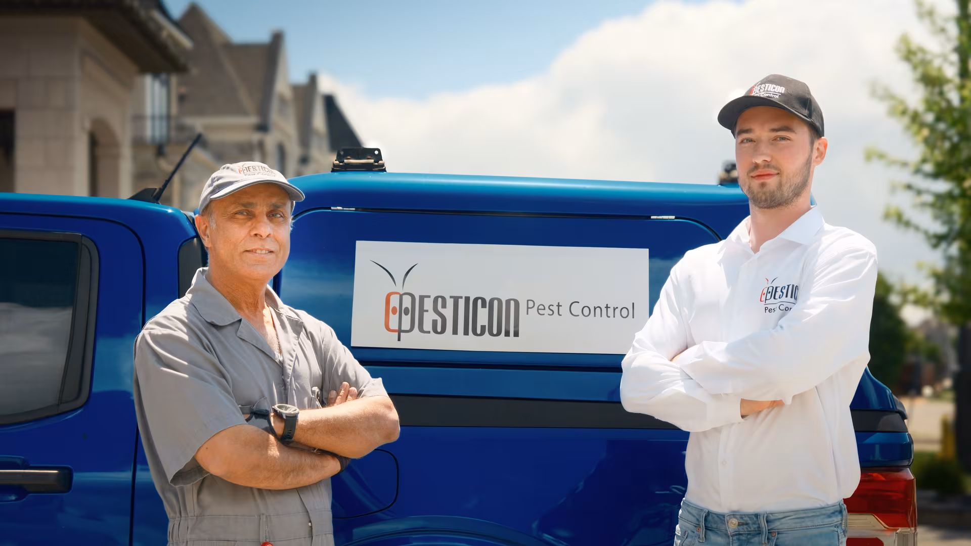 Two licensed Pesticon pest control technicians standing beside a branded Pesticon service van in Toronto