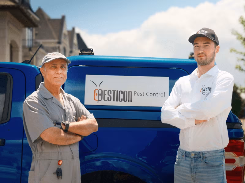 Pesticon bed bug exterminators standing beside branded pest control truck in Toronto